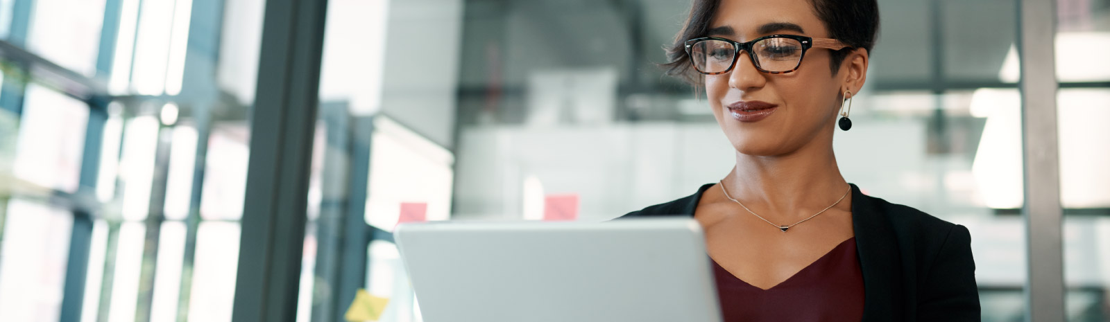 A business woman looks a her tablet