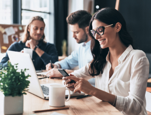 Woman smiling while collaborating with colleagues