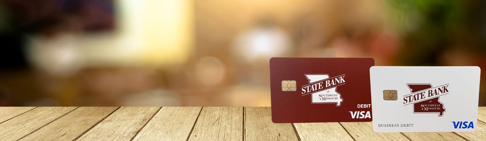 State Bank debit cards displayed on wood table