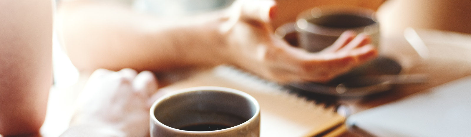 Two people with coffee mugs